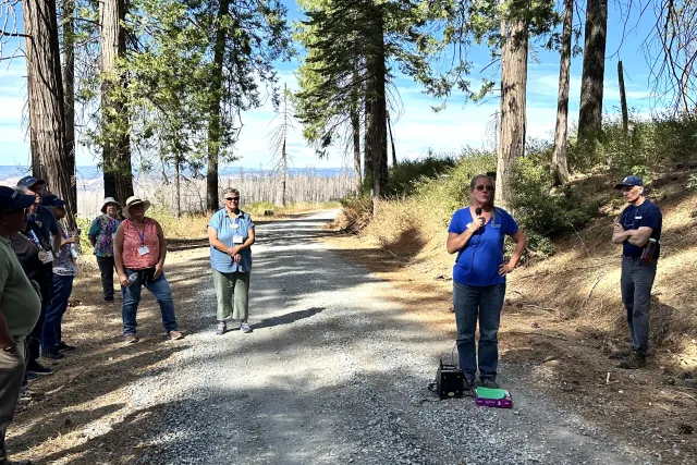 Susie Kocher addresses the tour group at Blodgett Forest