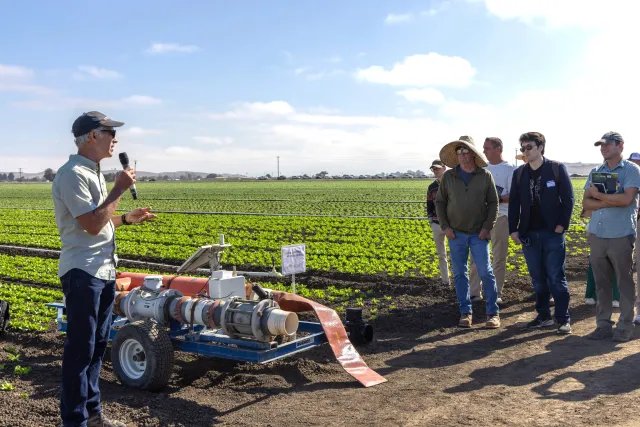 A field-day presenter explains irrigation technology to growers and agricultural professionals during UC ANR Innovate's Coastal Veg Field Day