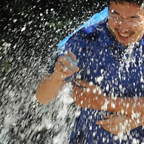 Wei Xu, of chemical ecologist Walter Leal's lab, gets drenched. (Photo by Kathy Keatley Garvey)