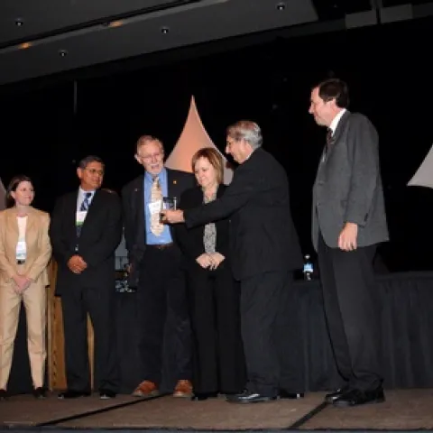 THE PRESENTATION--On stage for the ESA IPM Team Award are (from left) team member Dr. Barat Bisabri of Dow AgroSciences; Melissa Siebert, Dow AgroSciences, representing the sponsor of the award; team member Mario Viveros, UC Farm Advisor emeritus, Kern County; team member Walt Bentley, UC IPM advisor, UC Kearney Ag Center; team member Carolyn Pickel, UC IPM advisor, Sutter/Yuba counties; Dr. Bradley Vincent, presenting the award on behalf of the Entomological Foundation, and team member Dr. Frank Zalom, pro