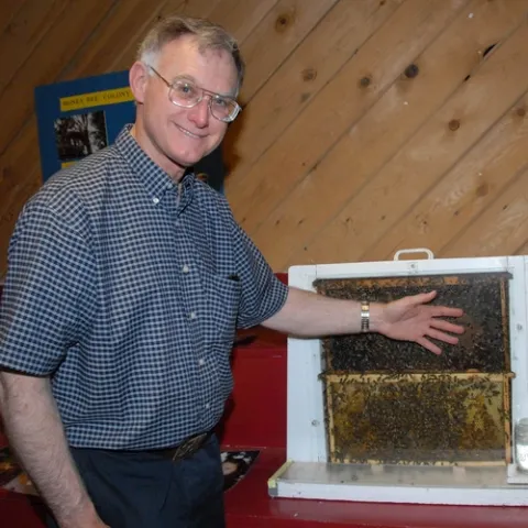 UC EXTENSION APICULTURIST Eric Mussen with a bee observation hive at the 2008 Dixon May Fair. The exhibit, featuring question-and-answer-sessions with Mussen, just won second place in a Western Fairs Association competition. (Photo by Kathy Keatley Garvey)