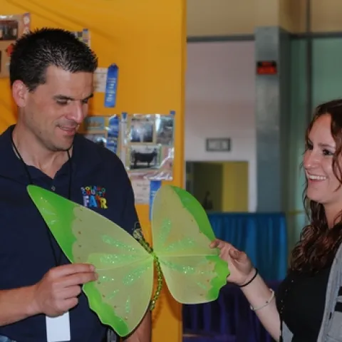 BUTTERFLIES abound at the Solano County Fair. Here assistant fair manager Chad Cabral (left) and Elisa Seppa, superintendent of McCormack Hall, look over a butterfly decoration. (Photo by Kathy Keatley Garvey)