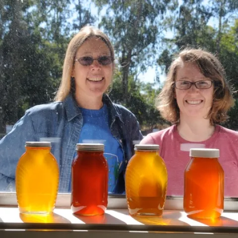 BEEKEEPERS outside the window of the Harry H. Laidlaw Jr. Honey Bee Research Facility at UC Davis. At left is bee breeder-geneticist Susan Cobey, manager of the Laidlaw Facility and a veteran beekeeper. With her is junior specialist Elizabeth Frost. (Photo by Kathy Keatley Garvey)