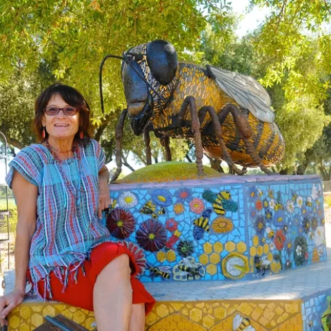 SELF-DESCRIBED rock artist Donna Billick with her sculpture, "Miss Bee Haven," at the Häagen-Dazs Honey Bee Haven at the Harry H. Laidlaw Jr. Honey Bee Research Facility, UC Davis. (Photo by Kathy Keatley Garvey)