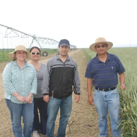 Fresno State professor Anil Shrestha (far right) with students at a research site.