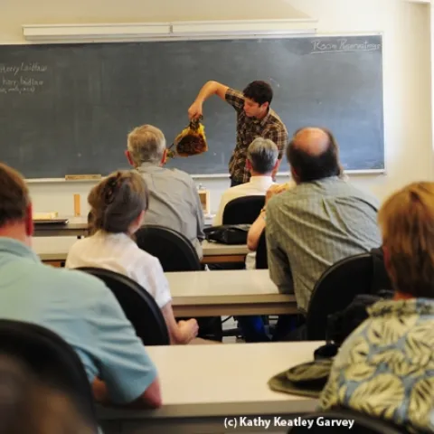 Billy Synk, manager of the Ladilaw facility, shows comb to the crowd in the Laidlaw conference room. (Photo by Kathy Keatley Garvey