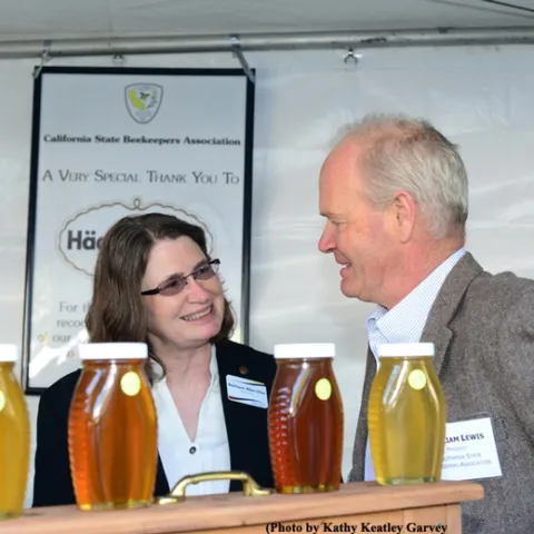 Barbara Allen-Diaz, vice president of UC ANR, "talks bees" with Bill Lewis, president of the California State Beekeepers' Association. (Photo by Kathy Keatley Garvey)