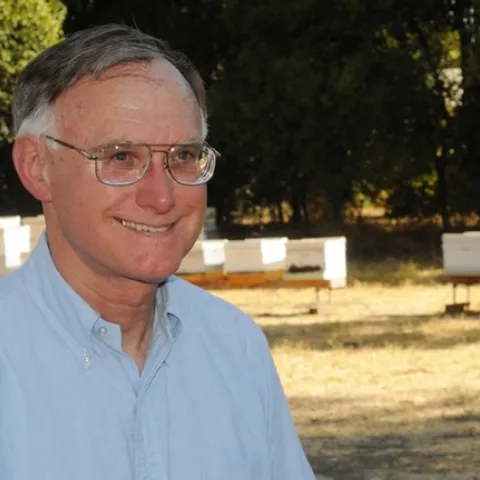 Extension apiculturist Eric Mussen in front of the apiary at the Harry H. Laidlaw Jr. Honey Bee Research Facility at UC Davis. (Photo by Kathy Keatley Garvey)