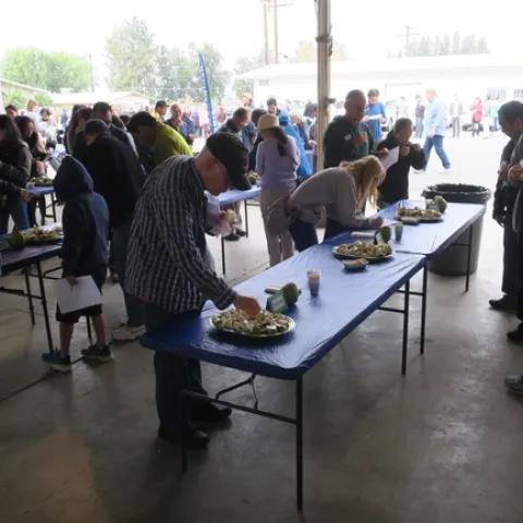 Attendees tasting cherimoya fruit.