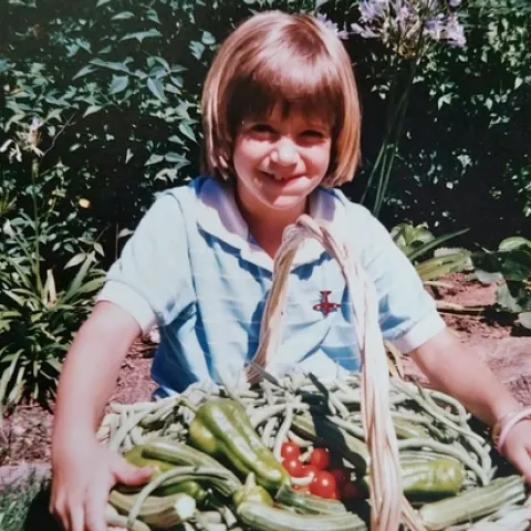 Statewide Training Coordinator Lauren Snowden showing off the summer harvest circa 1987