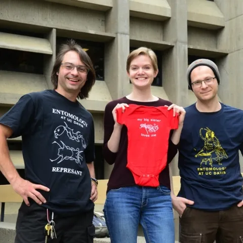 EGSA's 2018 t-shirt winners: Brendon Boudinot wearing his t-shirt, "REPRESANT"; Jill Oberski with her onesie, "My Sister Loves Me" and Corwin Parker wearing his "BarBeeCue" t-shirt. All are available online at https://mkt.com/UCDavisEntGrad/. (Photo by Kathy Keatley Garvey)