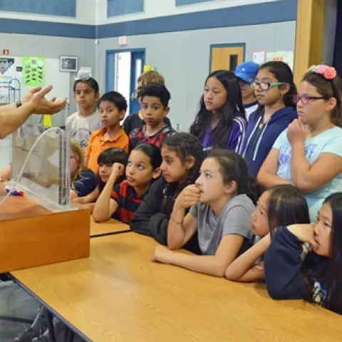 Dr. Sam Sandoval shows afterschool program youth a groundwater model. Photo by Marianne Bird.