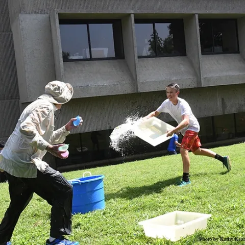 Scene One: UC Davis undergraduate student Andrew Kisin of the Aldrin Gomes lab, charges toward distinguished professor Bruce Hammock. (Photo by Kathy Keatley Garvey)