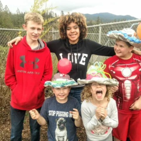 Macy Senter (center in black “LOVE” shirt) with students in the afterschool program.