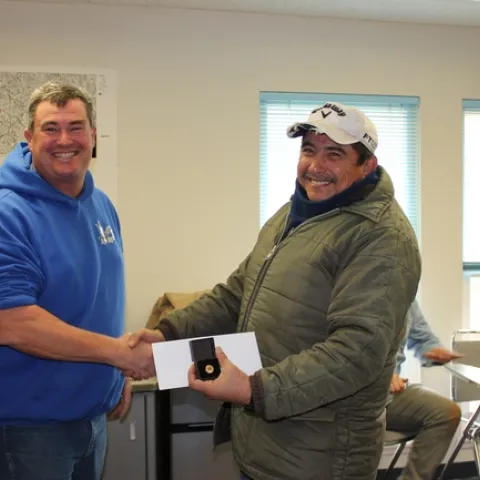 Abraham Mendoza accepts his 25 year service pin.