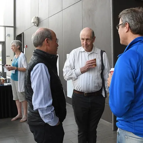 Bruce Hammock (center), UC Davis distinguished professor, greets guests at the reunion. (Photo by Kathy Keatley Garvey)