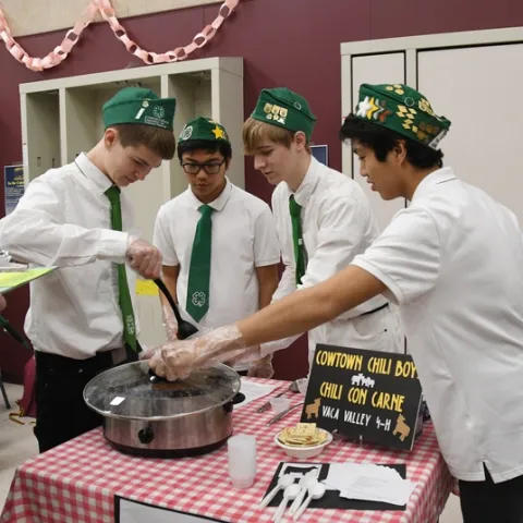 The Cowtown Chili Boys of the Vaca Valley 4-H Club--from left, Xander Lovell, Matthew Agbayani, Ian Weber and Francis Agbayani--test the temperature of their chili at the Solano County 4-H Chili Cook-Off. They went on the win the competition. (Photo by Kathy Keatley Garvey)