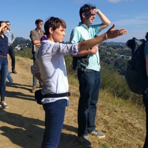 Nell Green Nylen (right) and her colleagues stop for a view of San Francisco Bay on a hike in the East Bay Hills above the UC Berkeley campus. Photo by Lidia Cano Pecharromán.