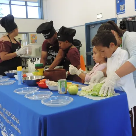 Families making special dishes for judges