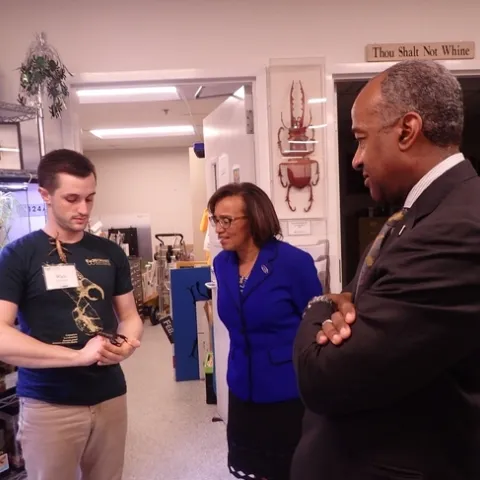 Bohart associate and entomology student Wade Spencer (left) shows Chancellor Gary May and Dean Helene Dillard a stick insect from the Bohart Museum of Entomology's petting zoo. (Photo by Kathy Keatley Garvey)