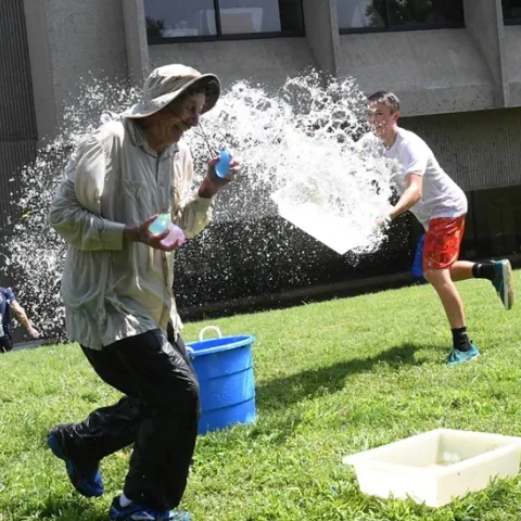 Undergraduate biological sciences major Andrew Kisin of the Aldrin Gomes lab, UC Davis Department of Neurbiology, PHysiology and Behavior, tosses a container of water at Bruce Hammock, UC Davis distinguished professor. (Photo by Kathy Keatley Garvey)