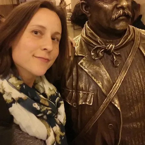 Doctoral student Rebecca Godwin won first place for her poster at the American Arachnological Society. This is Godwin with a statue of Theodore Roosevelt in the American Museum of Natural History. She was doing some work in the archives there for the Ummidia revision.