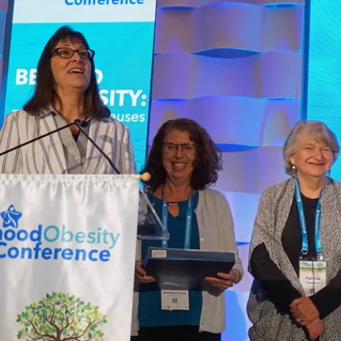 NPI director Lorrene Ritchie, left, and NPI associate director of research Gail Woodward-Lopez, honor NPI senior director of research emeritus Patricia Crawford (right) at the Childhood Obesity Conference.