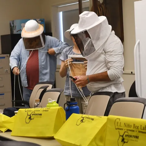Participants in the "Planning Ahead for Your First Hives" don protective veils. (Photo by Kathy Keatley Garvey)