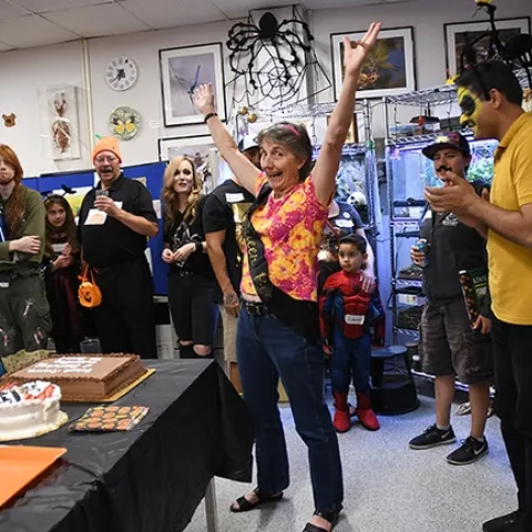 Lynn Kimsey, director of the Bohart Museum of Entomology, welcomes the crowd to the Halloween party. (Photo by Kathy Keatley Garvey)