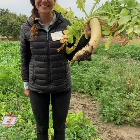 Alli Fish holding a radish.