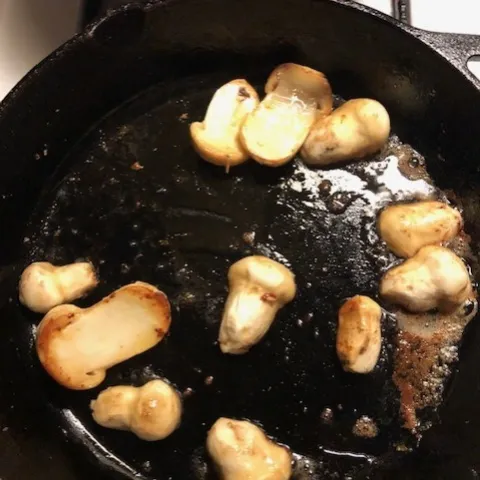 Fresh Matsutake mushrooms sauteéd golden brown.