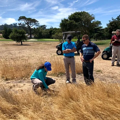 Maggie Reiter with stakeholders on a naturalized area of a golf course. Photo by James Hempfling.