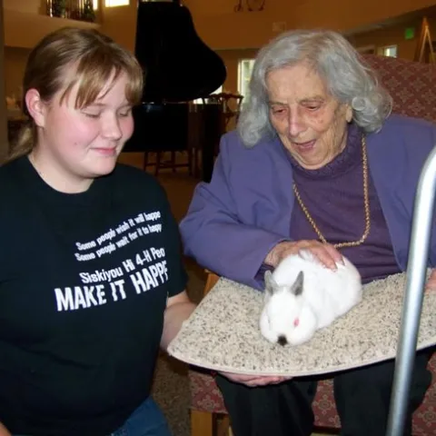 In one Siskiyou County 4-H activity, members visited residents of an assisted living facility with dogs and other animals.