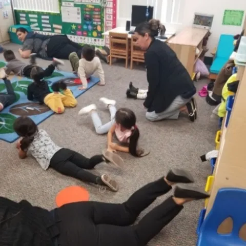 Students performing a CATCH ECE activity inside their classroom.