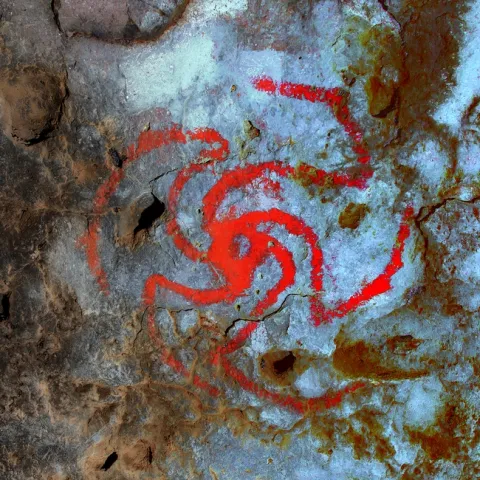 Scientists believe a red pinwheel painted in a Kern County cave by Native Americans depicts a Datura flower swirling open. (Photo: Rick Bury)