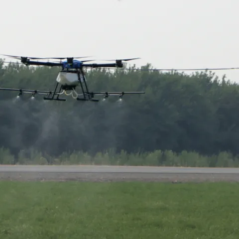 Photo 1. Drone application of pesticides for summer worm control in alfalfa hay.