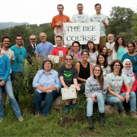In this 2015 Bee Course class photo, Charlie Nicholson (top, far left) holds the sign. In the second row, far left, is co-instructor Robbin Thorp, UC Davis distinguished emeritus professor of entomology. Nicholson is the winner of the inaugural Robbin Thorp Memorial First-Bumble-Bee-of-the-Year Contest, sponsored by the Bohart Museum of Entomology. (Photo courtesy of The Bee Course)
