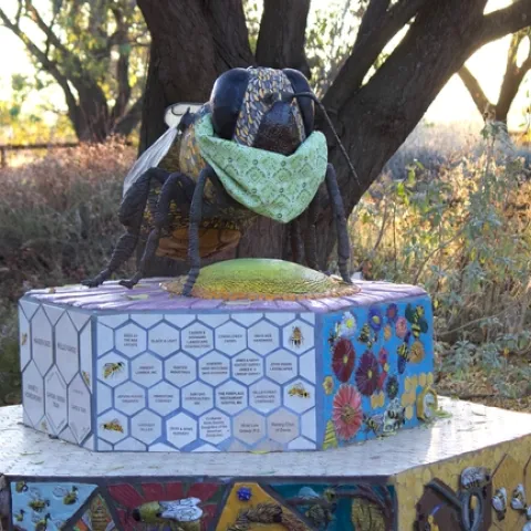 Bee statue at the Haven wearing a mask