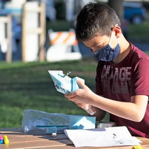 Fifth-grader Sarp Akalin designs and builds a battery-powered motorboat for Engineers Week. All photos by Evett Kilmartin