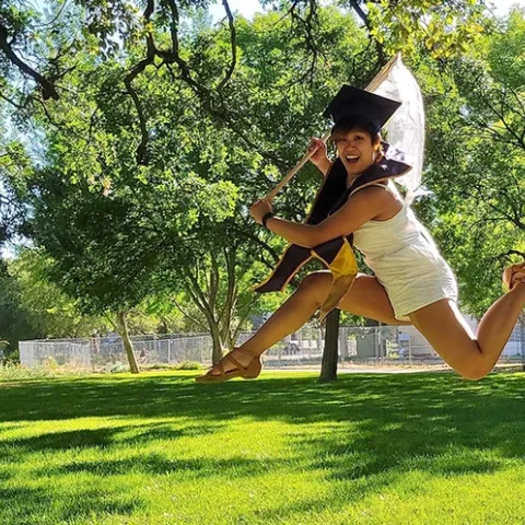 This image of UC Davis entomology graduate RJ Millena shows her jumping for joy while wielding an insect net. (Photo by Kaylee Fagan)
