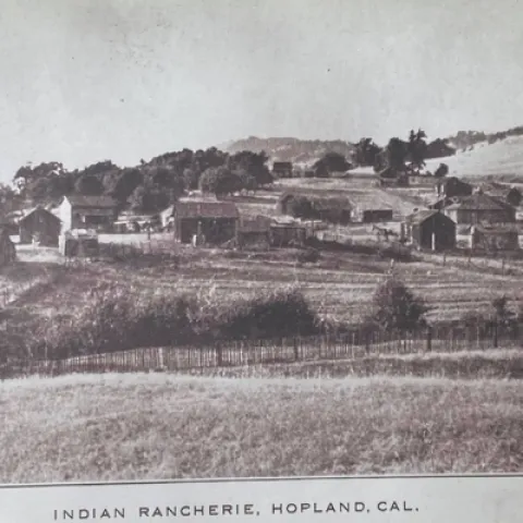 Sepia-tone image of one-story structures.