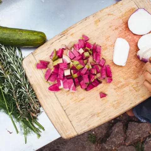 Vegetables being sliced up on a cutting board