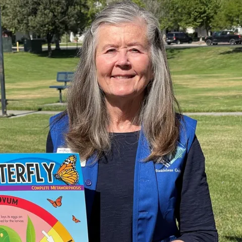 A photo of the author wearing a blue Master Gardener vest.