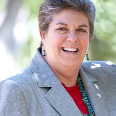 Headshot of Glenda Humiston wearing gray blazer over a red top.