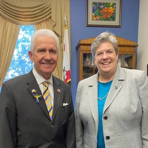 Jim Costa, left, poses beside Glenda Humiston in his office. A U.S. flag hangs behind his shoulder.
