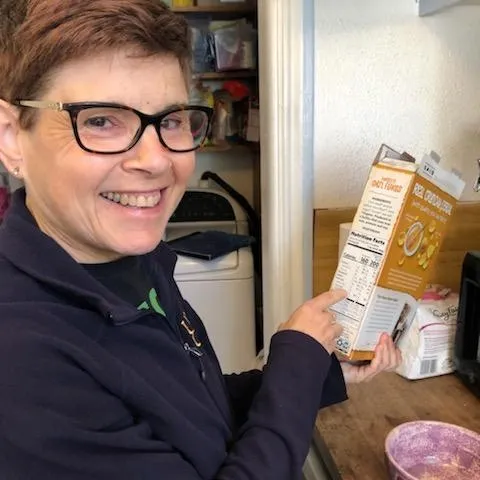 Elaine Silver points to nutrition facts on a cereal box.