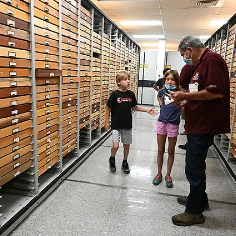 Niccoli Zebouni, 7, and his sister Clio, 9, rush to greet Bohart associate Greg Kareofelas to learn more about butterflies. (Photo by Kathy Keatley Garvey)