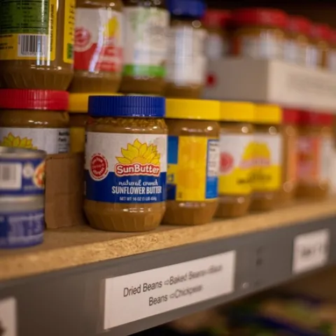 A shelf of dry goods on a food pantry shelf
