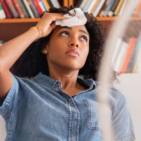A woman wipes her brow due to extreme heat