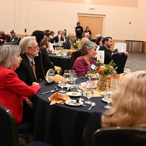 Bill Patterson and his wife, Doris Brown (left), listen to the UC Davis College of Agricultural and Environmental Sciences' Award of Distinction program. At right is Lynn Kimsey, director of the Bohart Museum of Entomology. (Photo by Kathy Keatley Garvey)